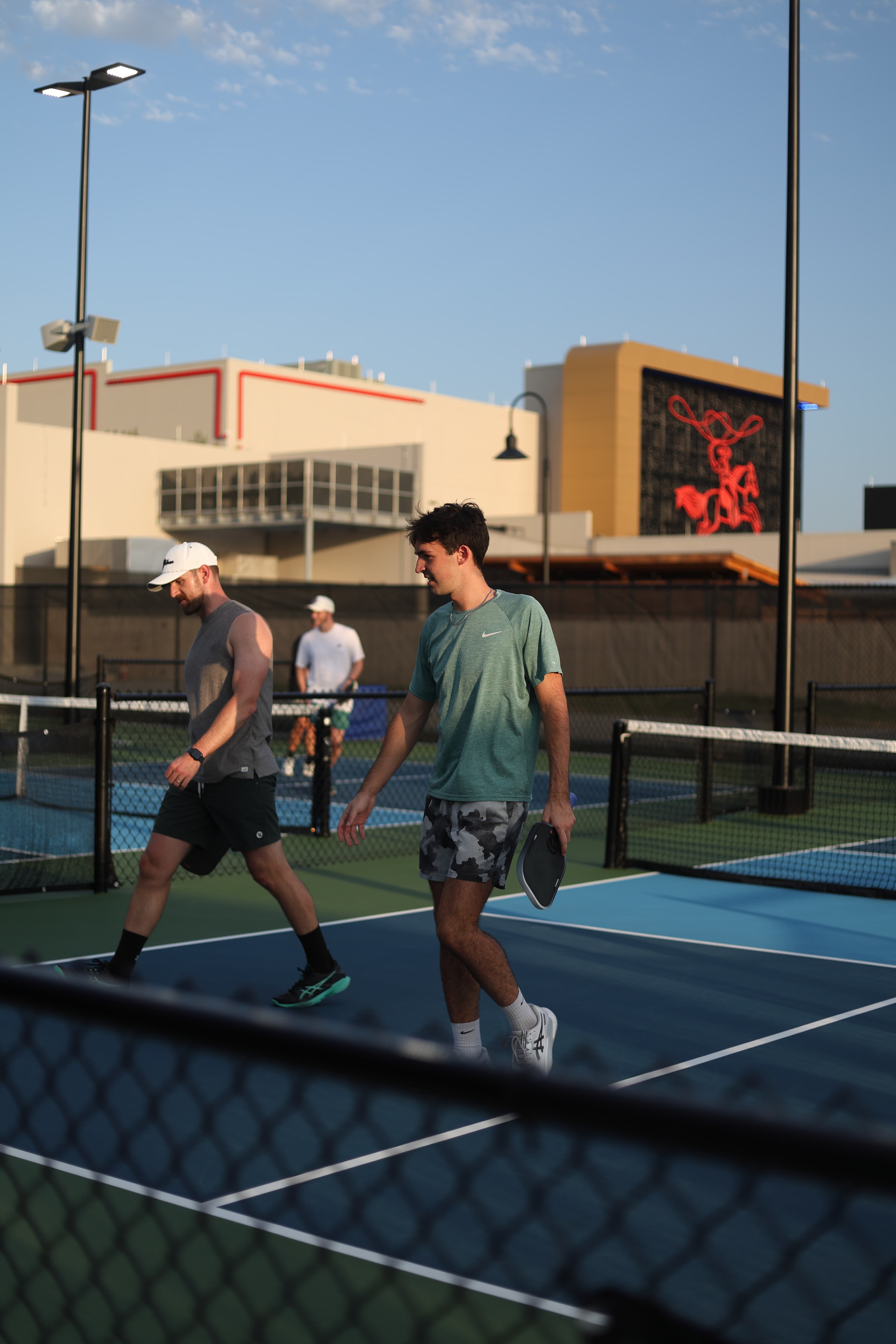 Jackson high-fiving another pickleball player